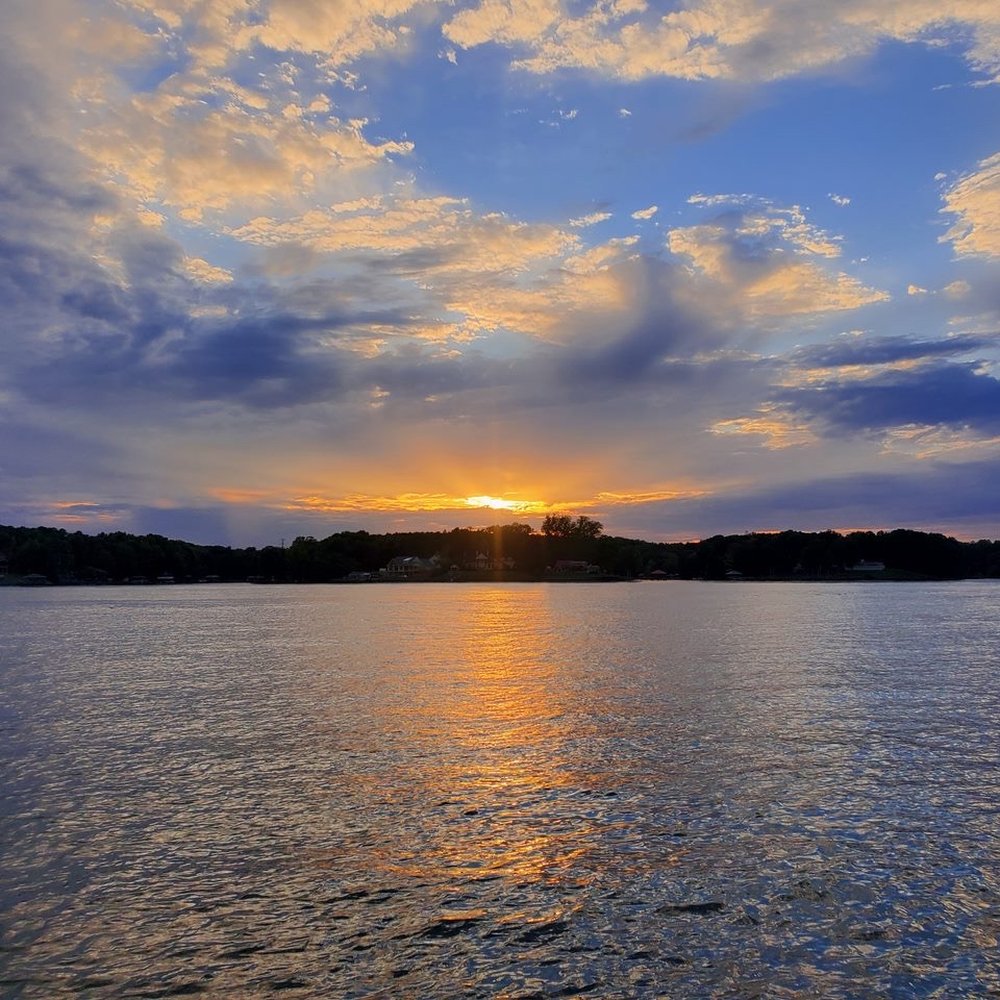 Sunset over Lake Wylie at The Grove at Tega Cay new construction community in South Carolina